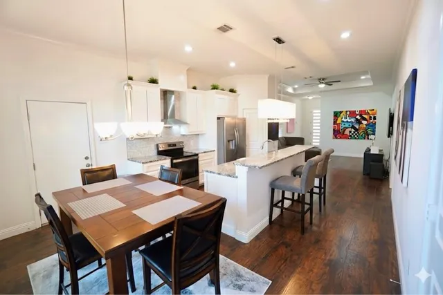 a view of a dining room with furniture and wooden floor