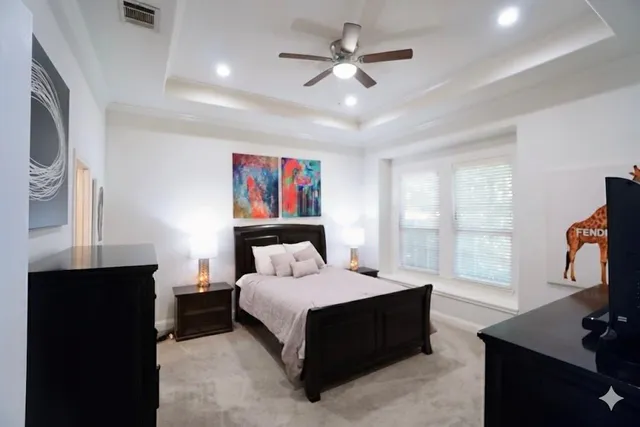 a bedroom with a bed window and a flat screen tv
