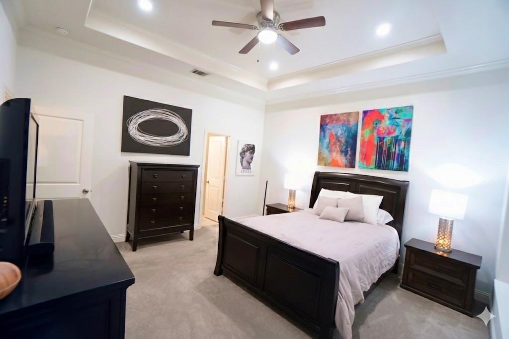 1439 Stella Avenue Dallas, TX 75216 - Photo 8 of 13 a bed room with a bed and a television