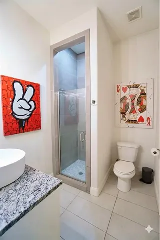 a bathroom with a toilet sink and shower