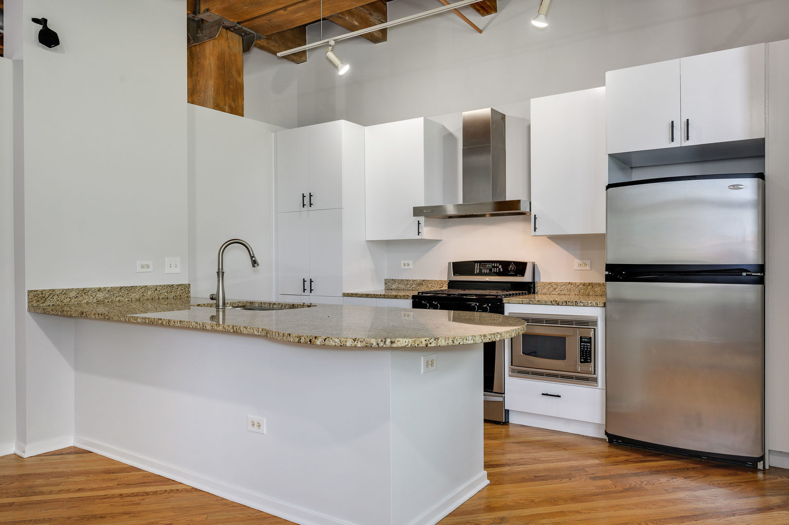 1040 West Adams Street, Unit 269 Chicago, IL 60607 - Photo 7 of 23 a kitchen with stainless steel appliances granite countertop a sink stove and refrigerator