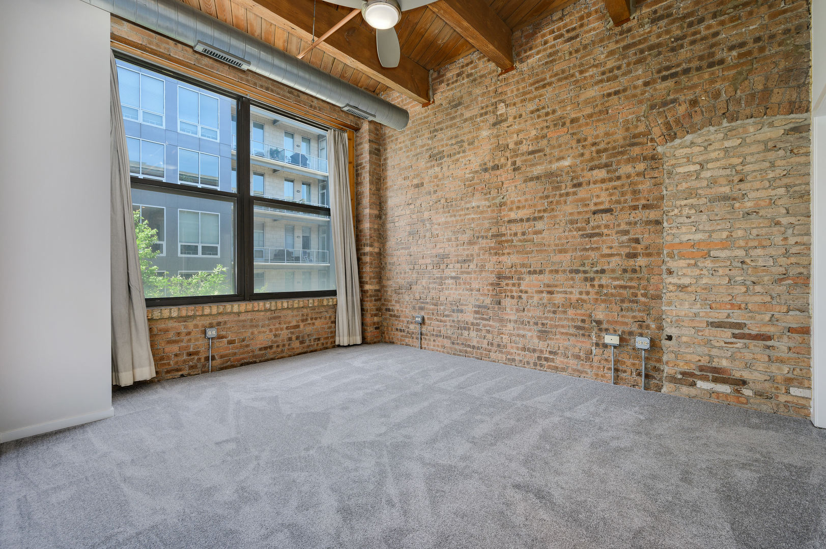 1040 West Adams Street, Unit 269 Chicago, IL 60607 - Photo 9 of 23 a view of an empty room with a window