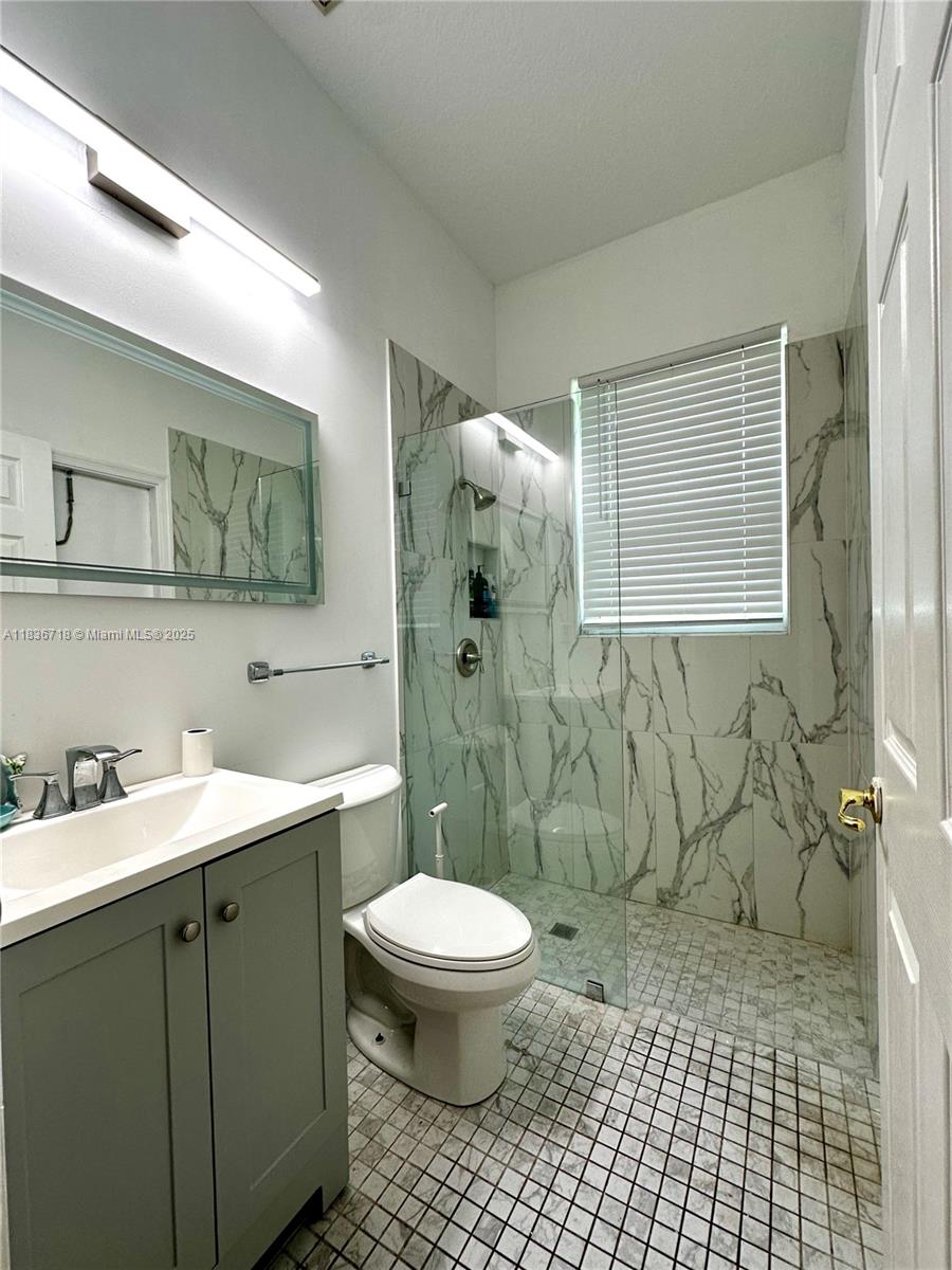 422 Oriole Circle Jupiter, FL 33458 - Photo 13 of 16 a bathroom with a sink toilet and shower