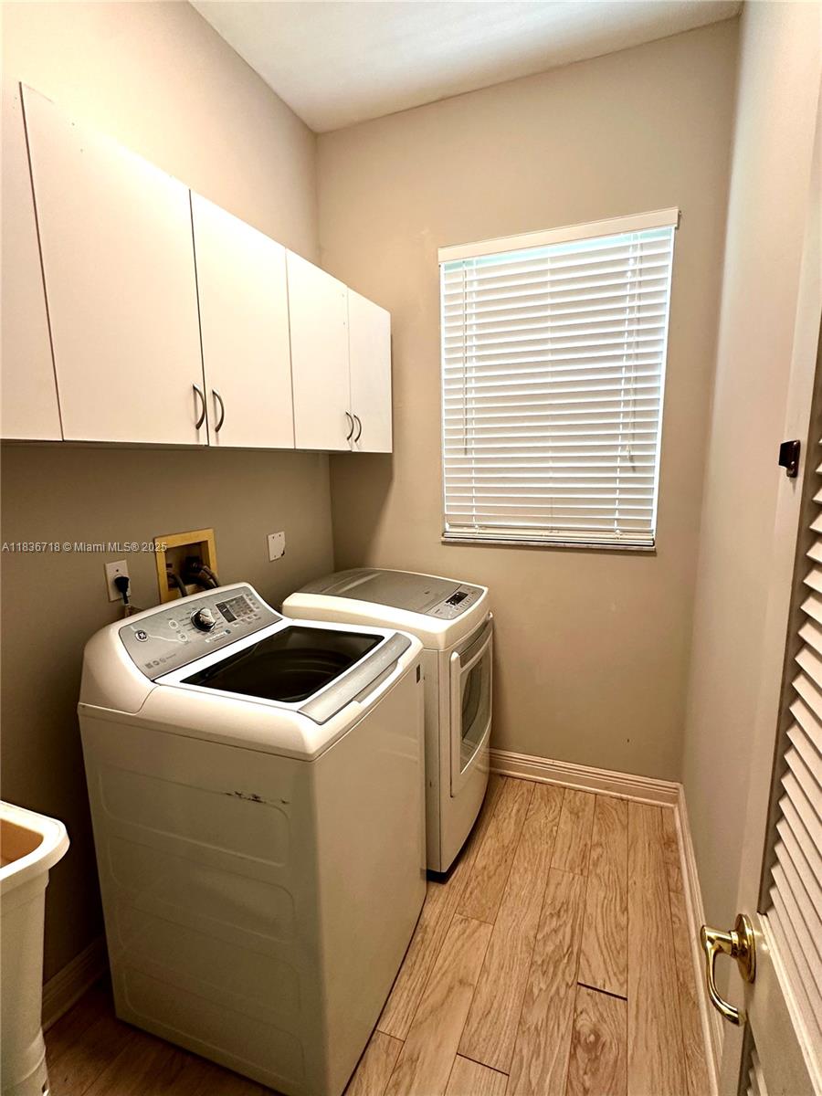 422 Oriole Circle Jupiter, FL 33458 - Photo 14 of 16 a utility room with dryer and washer