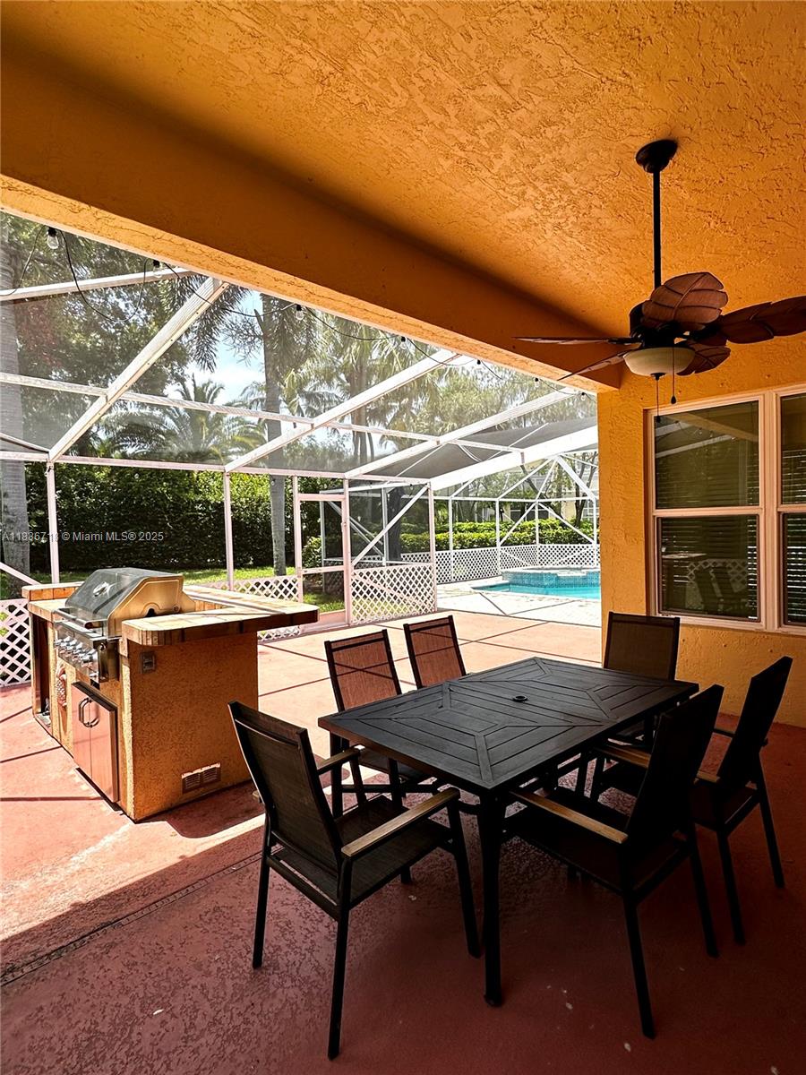 422 Oriole Circle Jupiter, FL 33458 - Photo 5 of 16 a view of a patio with a table chairs and a backyard