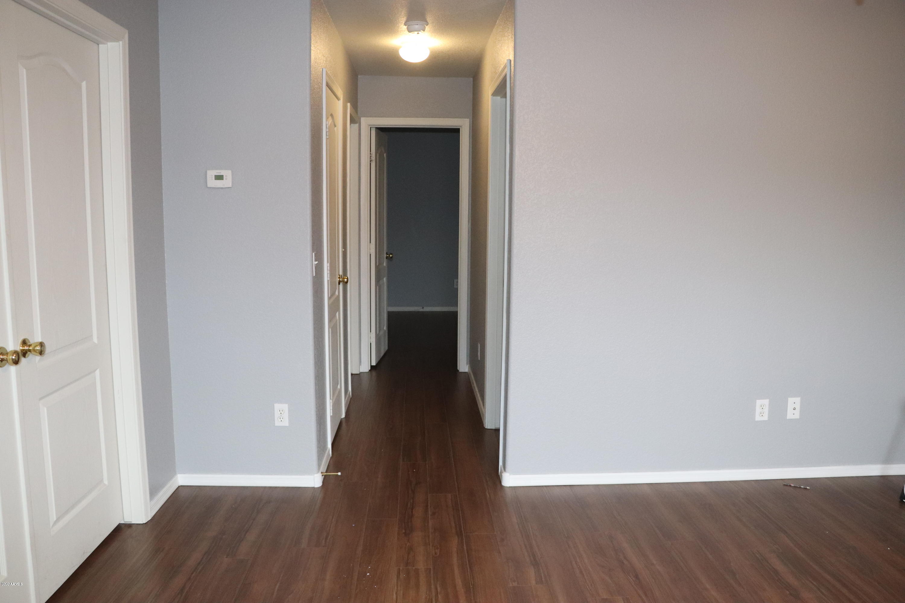 3387 South Chaparral Road Apache Junction, AZ 85119 - Photo 23 of 32 a view of a hallway with wooden floor