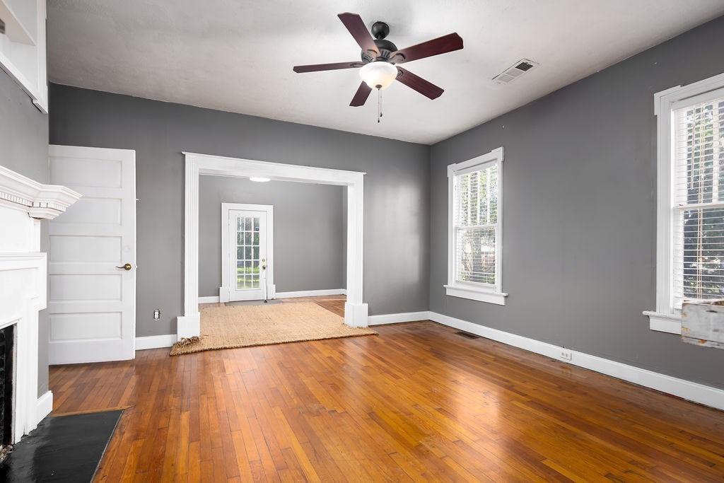 1024 18th Street Columbus, GA 31901 - Photo 12 of 20 a view of an empty room with wooden floor and a window