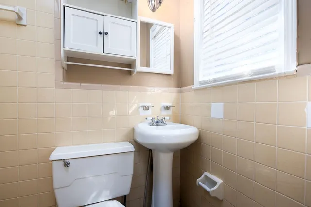 a bathroom with a sink a mirror and a toilet