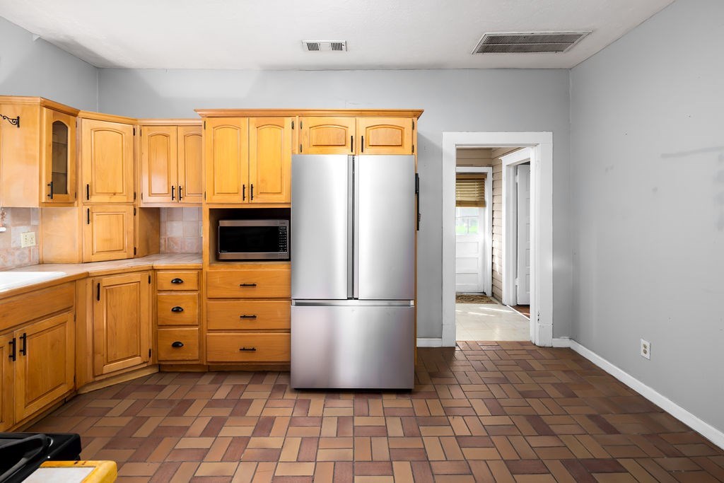 1024 18th Street Columbus, GA 31901 - Photo 6 of 20 a kitchen with stainless steel appliances a refrigerator sink and cabinets