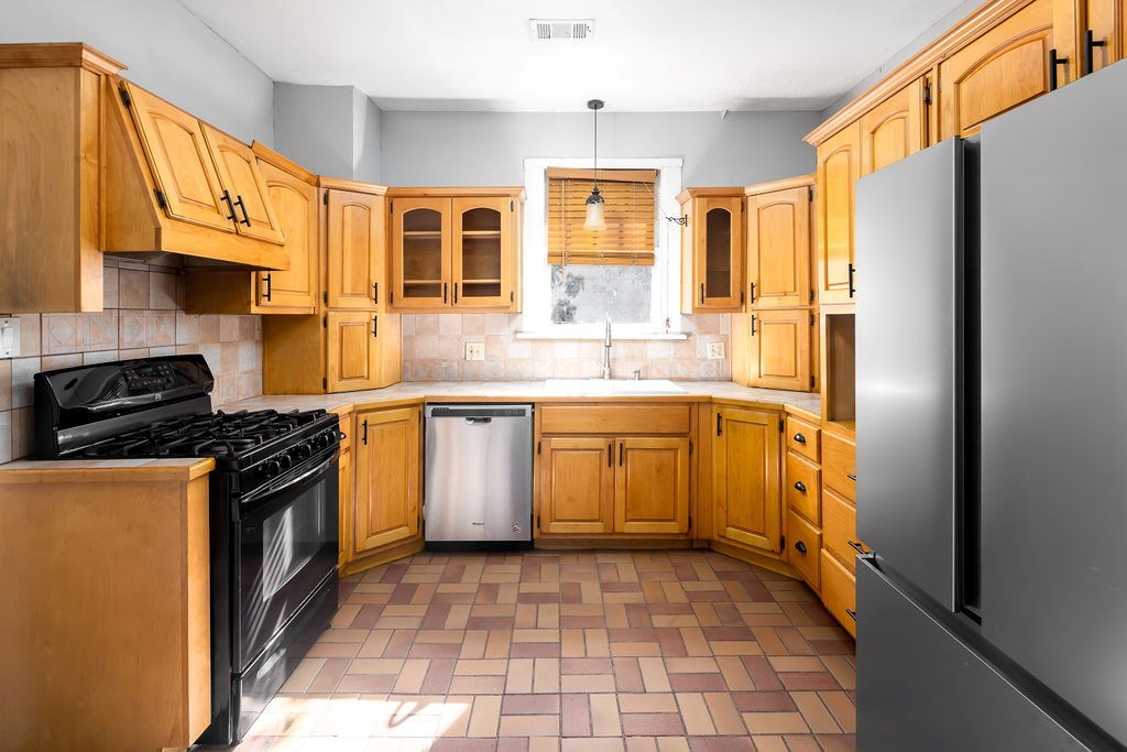 1024 18th Street Columbus, GA 31901 - Photo 7 of 20 a kitchen with a sink stove and refrigerator