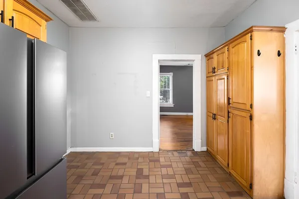 a view of a hallway with wooden floor and closet