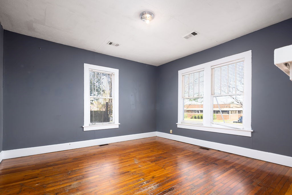 1024 18th Street Columbus, GA 31901 - Photo 10 of 20 a view of an empty room with wooden floor and a window