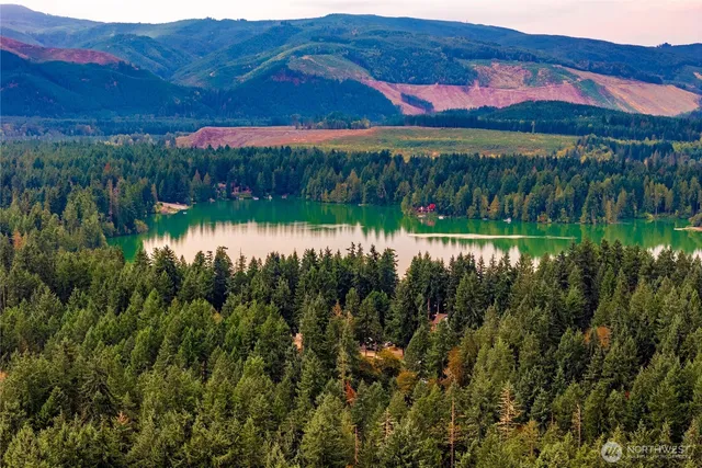 a view of lake with a house in the background
