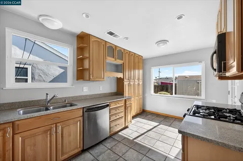 a kitchen with stainless steel appliances a sink a stove and a refrigerator