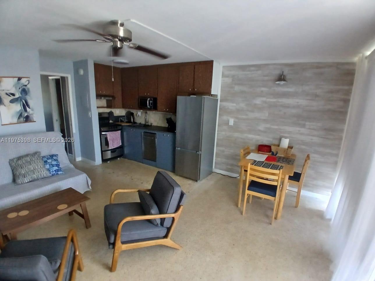 901 North Birch Road, Unit 9B Fort Lauderdale, FL 33304 - Photo 2 of 12 a living room with furniture and a kitchen area