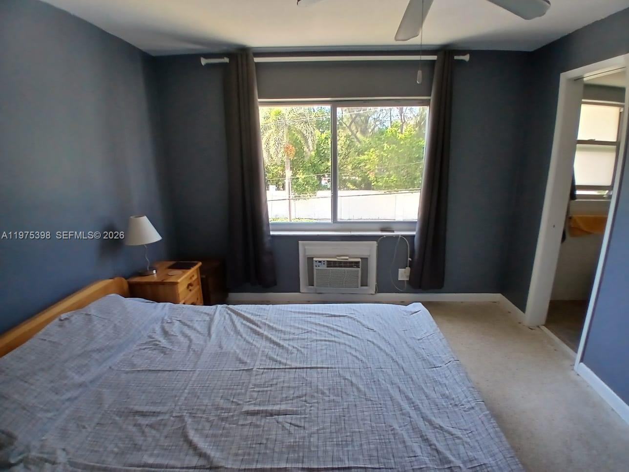 901 North Birch Road, Unit 9B Fort Lauderdale, FL 33304 - Photo 3 of 12 a bedroom with a bed and a window