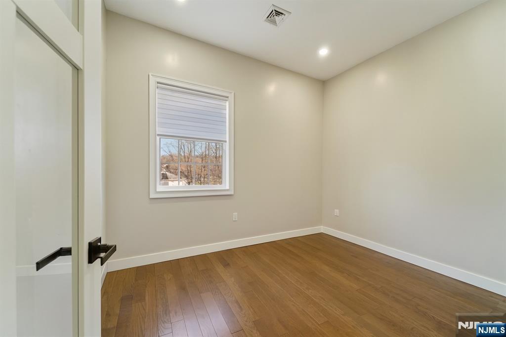 24 Holmes Lane Wayne, NJ 07470 - Photo 29 of 47 a view of a room with wooden floor and window