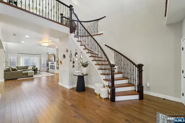 a view of entryway and hall with wooden floor