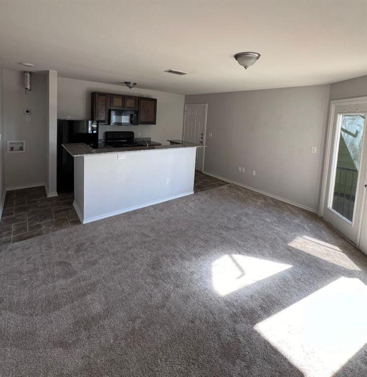 a kitchen with stainless steel appliances a microwave a stove top oven and a sink