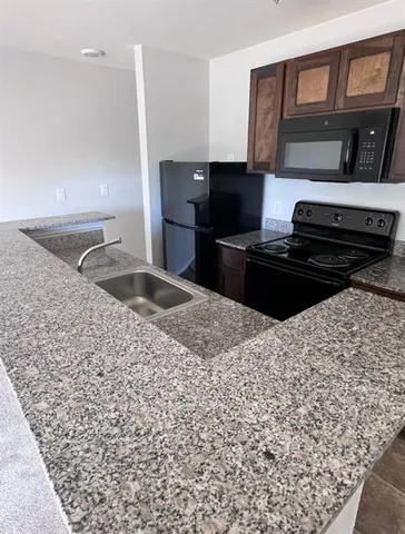 a kitchen with a sink stove and refrigerator