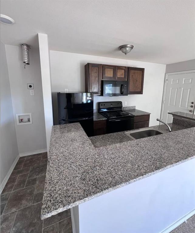 9837 Walnut Street, Unit 305 Dallas, TX 75243 - Photo 3 of 10 a kitchen with stainless steel appliances granite countertop a sink stove and refrigerator
