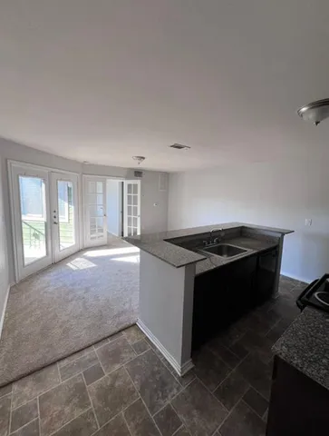 a kitchen with a stove and a granite counter tops