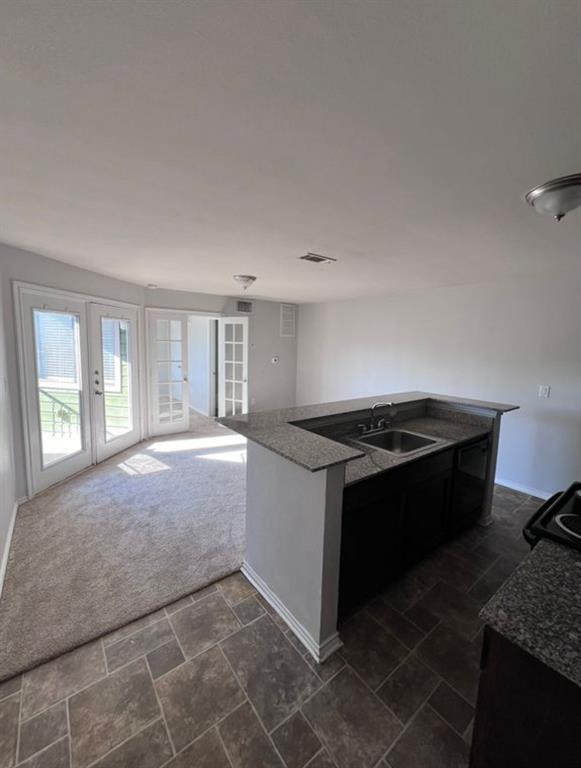 9837 Walnut Street, Unit 305 Dallas, TX 75243 - Photo 4 of 10 a kitchen with a stove and a granite counter tops