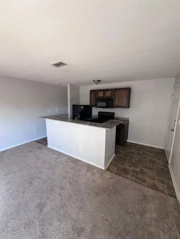 a kitchen with stainless steel appliances a sink a stove top oven and white cabinets