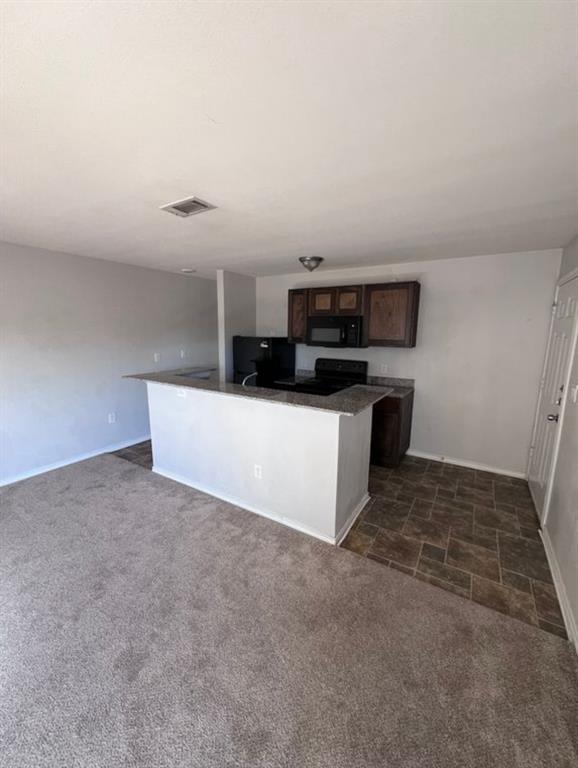 9837 Walnut Street, Unit 305 Dallas, TX 75243 - Photo 5 of 10 a kitchen with stainless steel appliances a sink a stove top oven and white cabinets