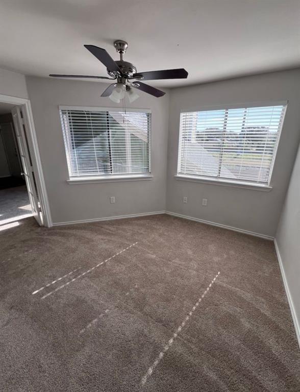 9837 Walnut Street, Unit 305 Dallas, TX 75243 - Photo 7 of 10 an empty room with windows and fan