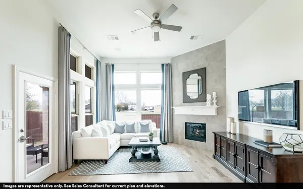 a living room with fireplace furniture and a large window