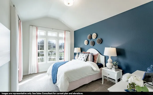 a bedroom with a bed and a large mirror