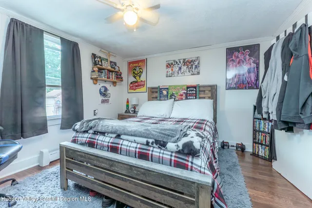 a bedroom with bed and wooden floor