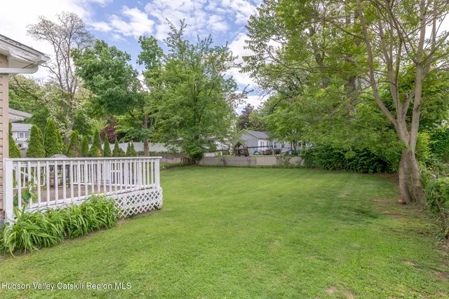 a view of a deck in front of house with trees