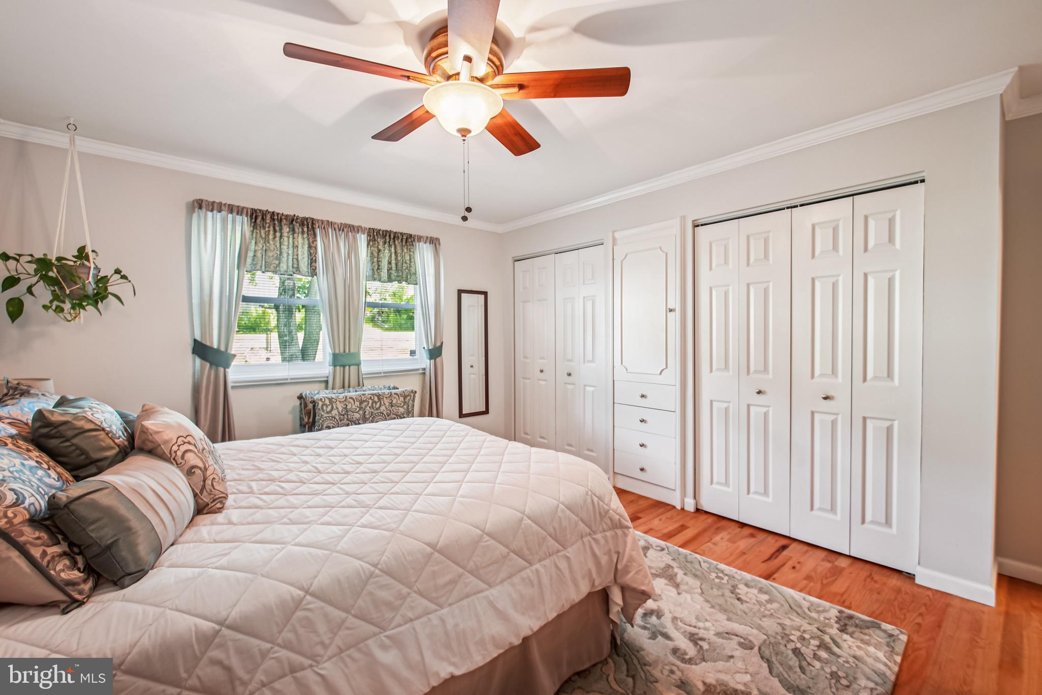 8113 Callo Lane Rosedale, MD 21237 - Photo 18 of 32 a bedroom with a bed and a chandelier