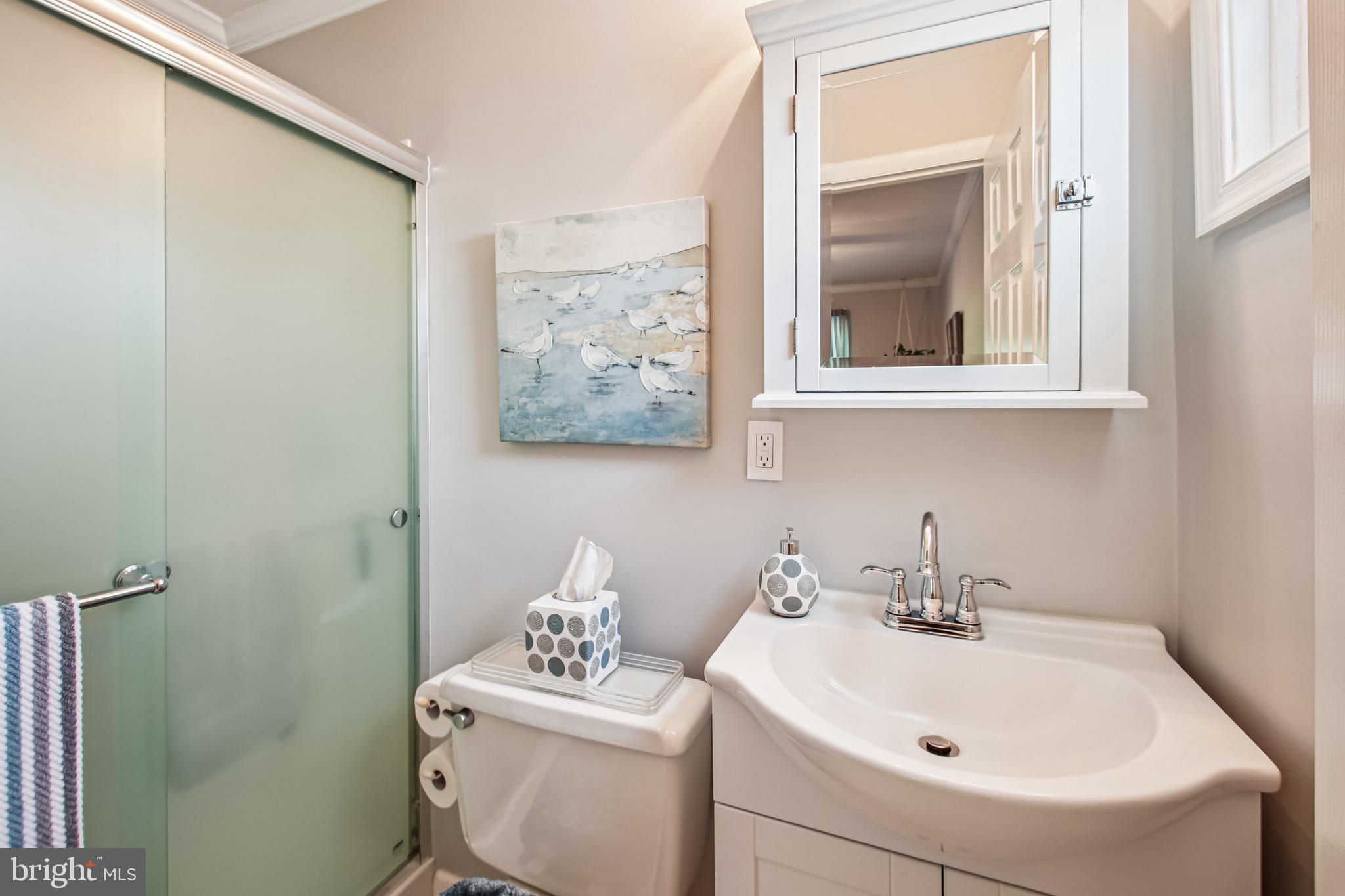 8113 Callo Lane Rosedale, MD 21237 - Photo 19 of 32 a bathroom with a sink mirror and toilet