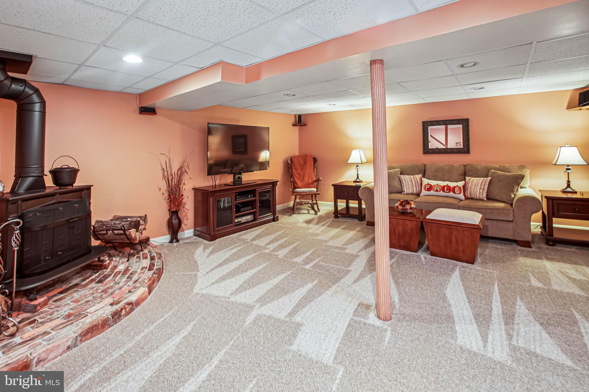 8113 Callo Lane Rosedale, MD 21237 - Photo 25 of 32 a living room with furniture a flat screen tv and a fireplace