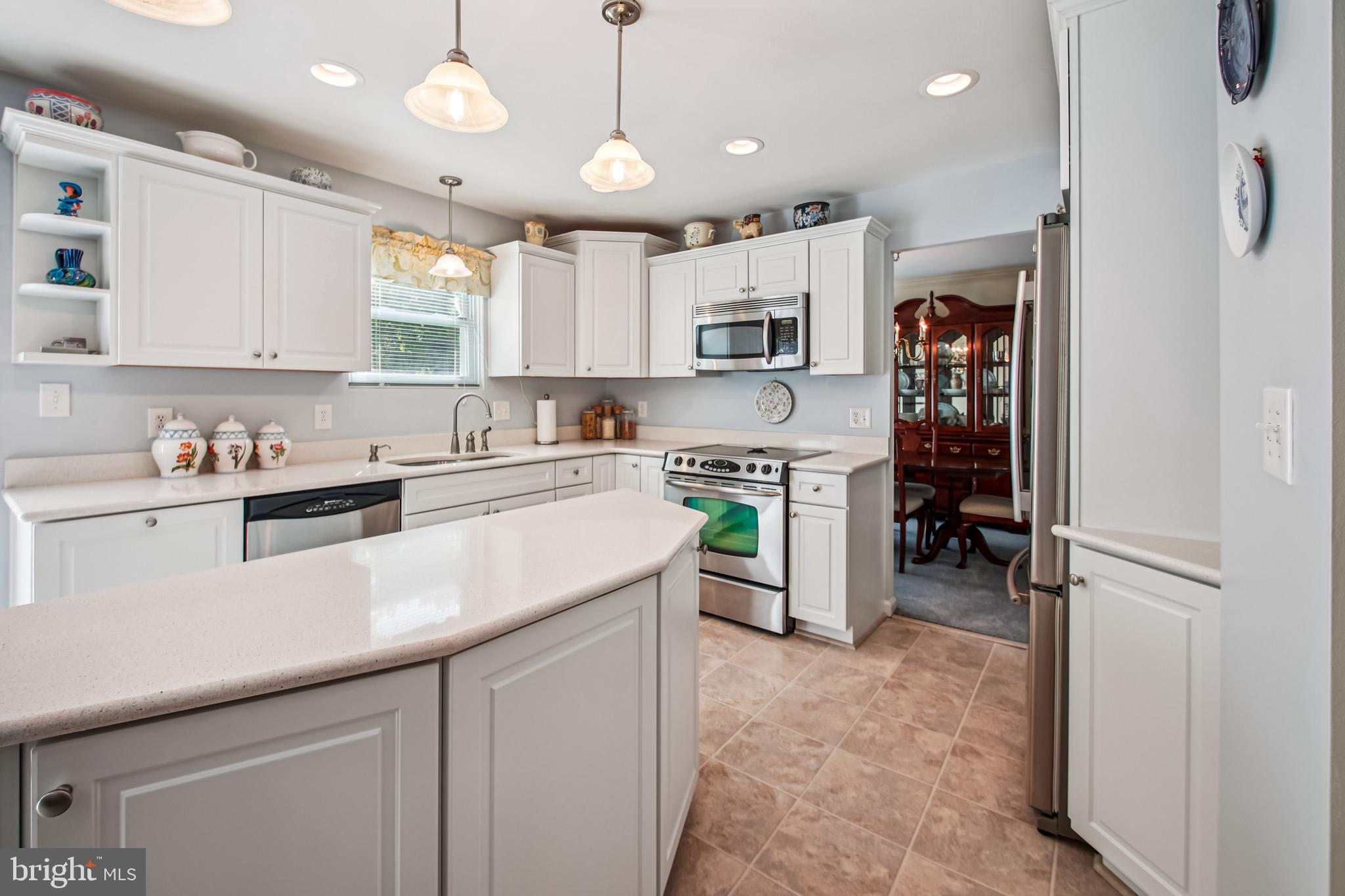 8113 Callo Lane Rosedale, MD 21237 - Photo 7 of 32 a kitchen with stainless steel appliances granite countertop a sink stove and refrigerator