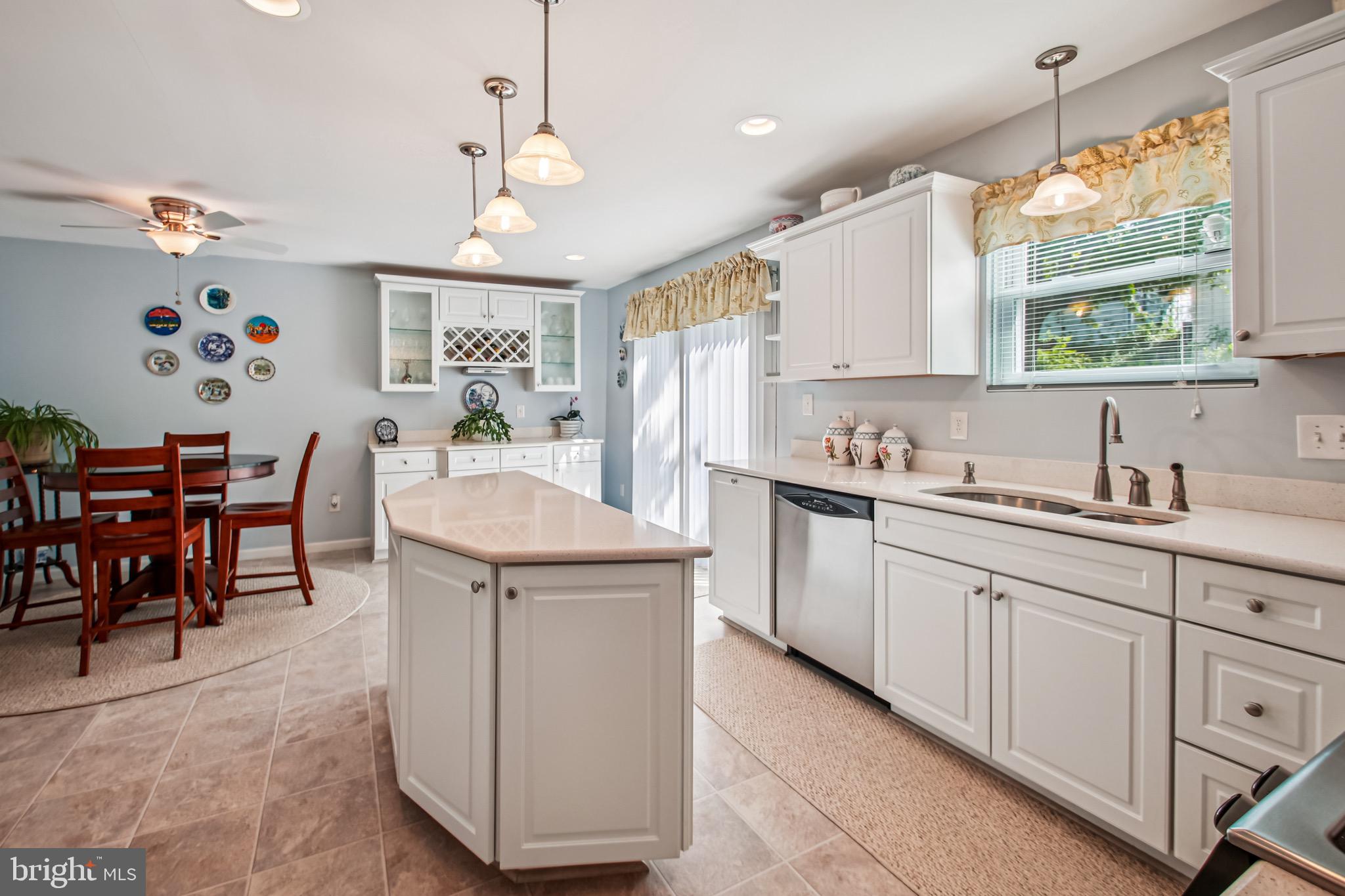 8113 Callo Lane Rosedale, MD 21237 - Photo 10 of 32 a kitchen that has a cabinets counter space dining table and a large window