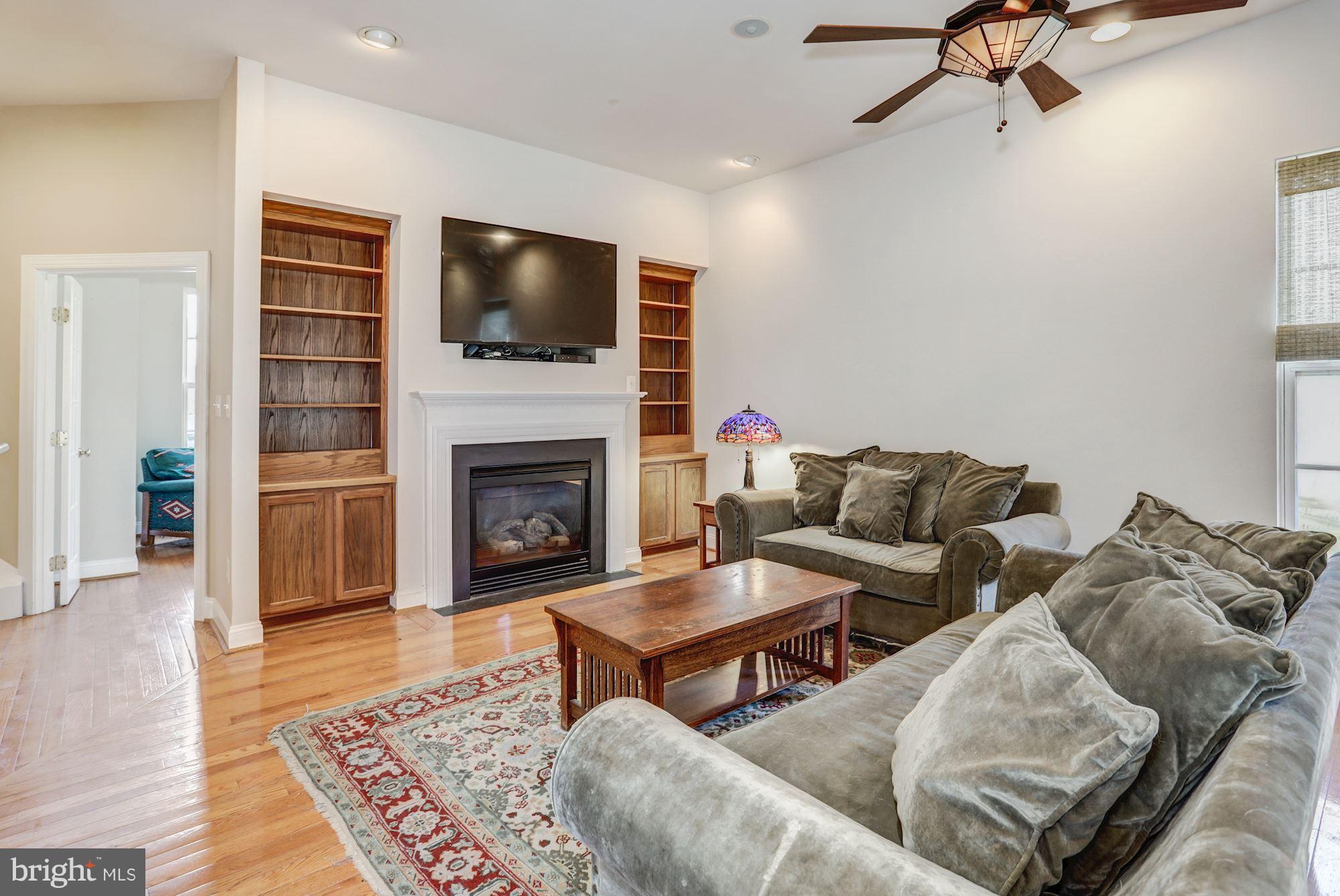 9029 Roaring Spring Loop Bristow, VA 20136 - Photo 11 of 28 Family Room with gas fireplace and built-ins
