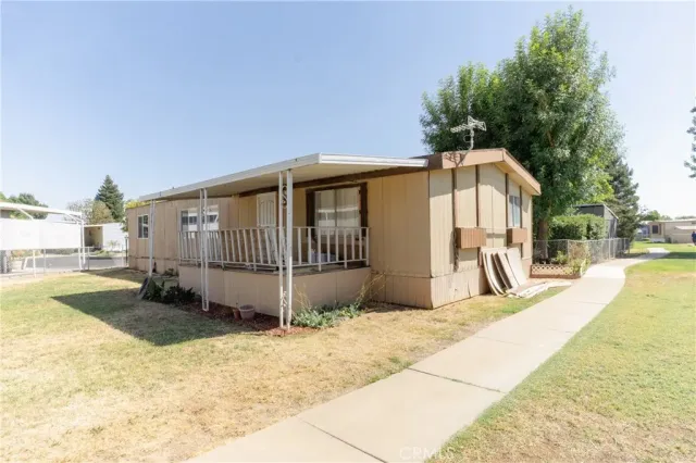 a view of a house with a yard and a tub