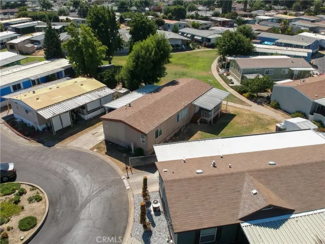 an aerial view of a house with a yard and lake view