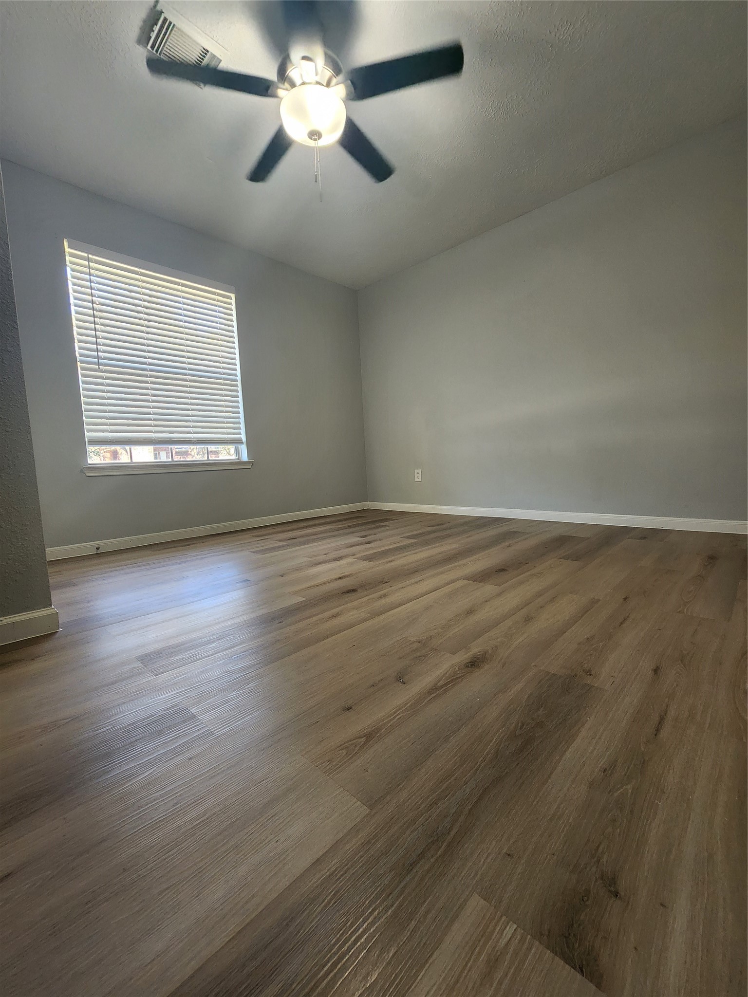 5507 Clarkston Lane Spring, TX 77379 - Photo 12 of 25 a view of an empty room with wooden floor and a window