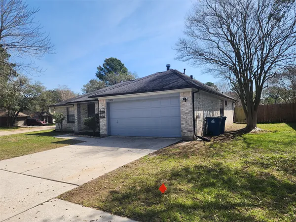 a front view of house with yard and trees around