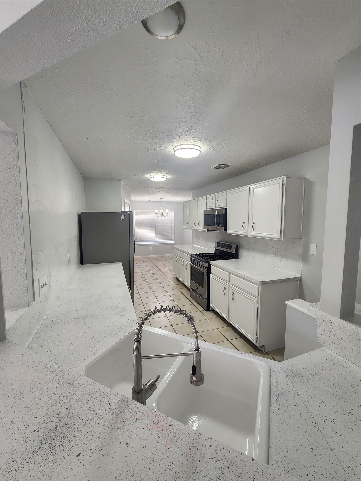 5507 Clarkston Lane Spring, TX 77379 - Photo 6 of 25 a kitchen with a sink cabinets and wooden floor