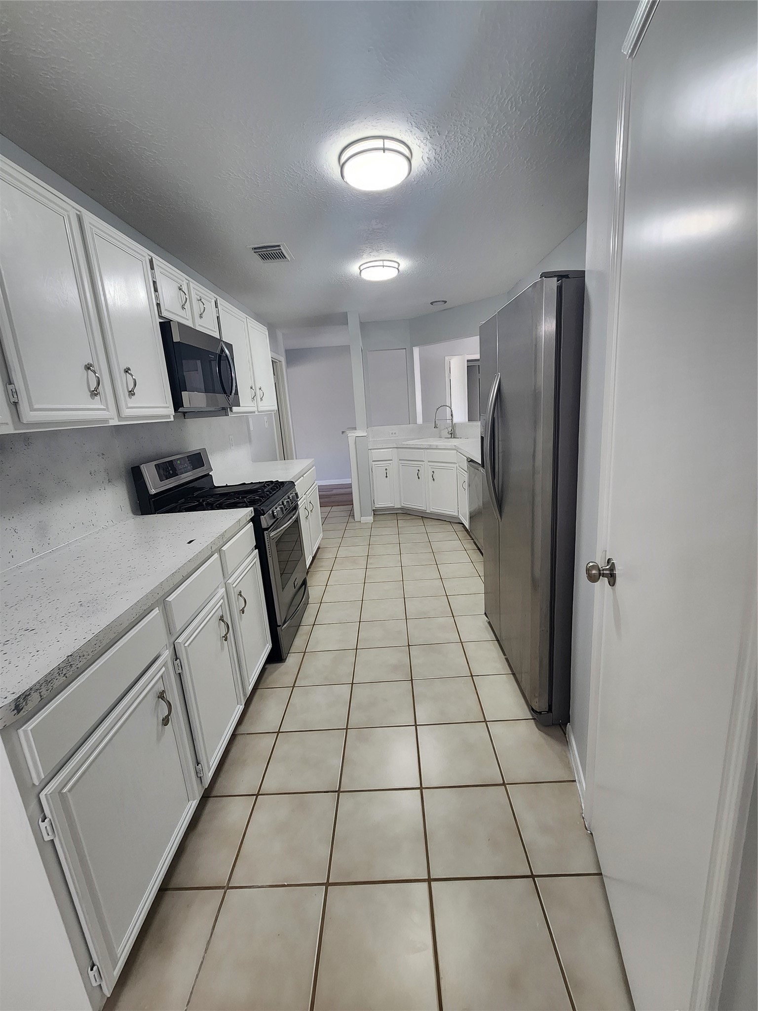 5507 Clarkston Lane Spring, TX 77379 - Photo 7 of 25 a kitchen with stainless steel appliances a refrigerator sink and microwave