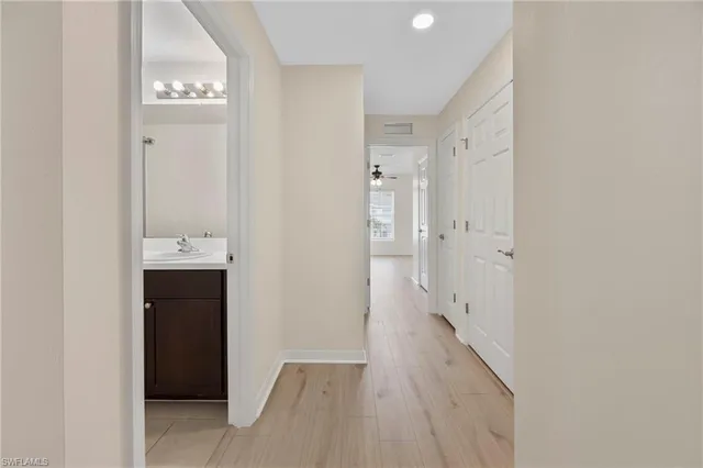 a view of hallway with wooden floor