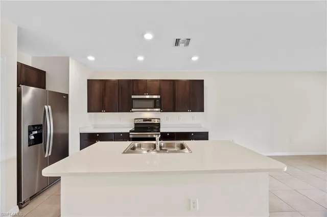 a kitchen with stainless steel appliances a refrigerator and a stove