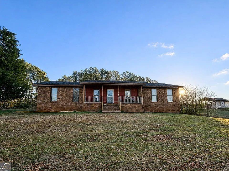 781 Thomas Street Roopville, GA 30170 - Photo 1 of 14 a front view of house with yard and trees