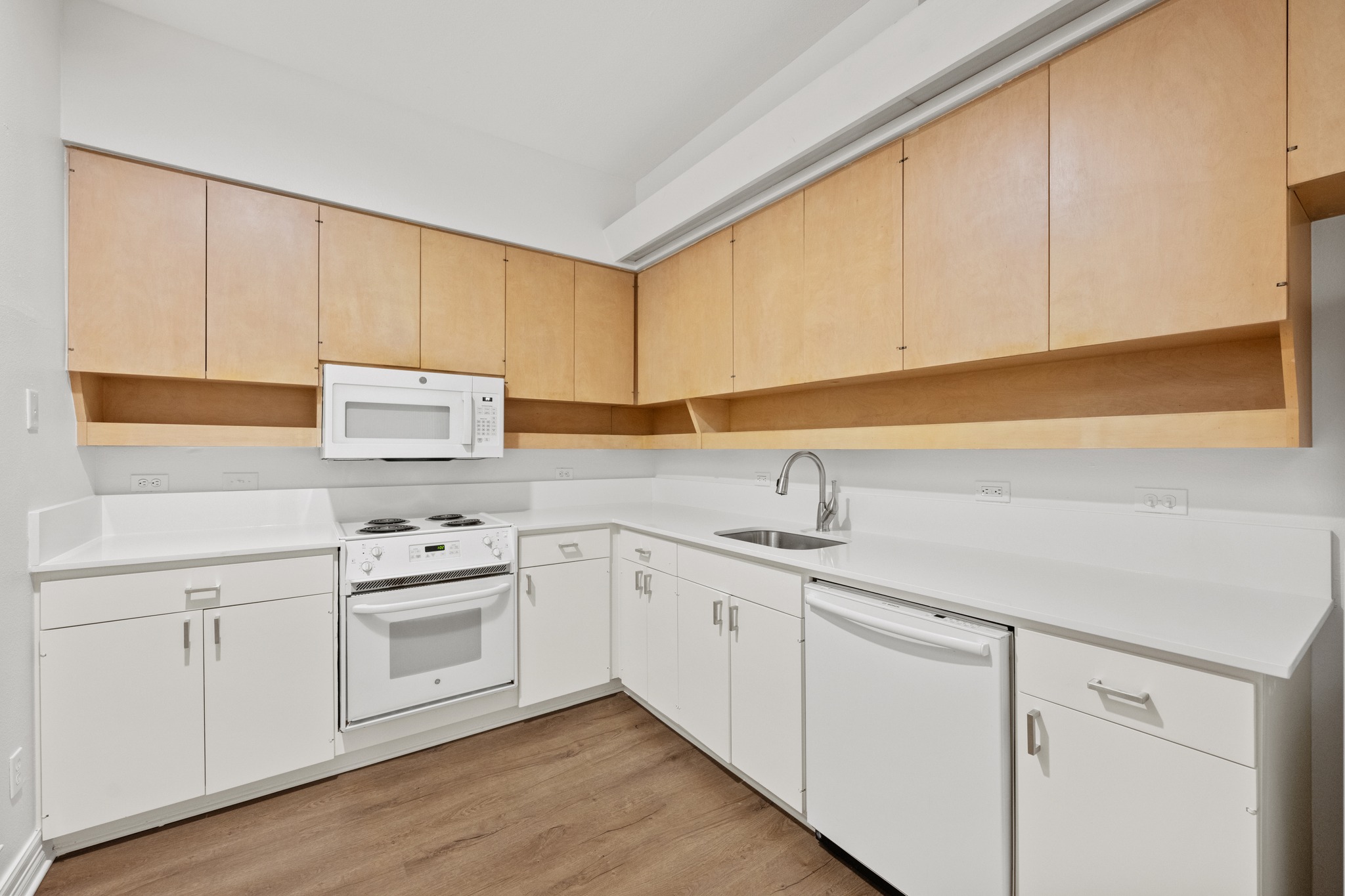 409 East 38th Street, Unit 101 Austin, TX 78705 - Photo 9 of 27 A well-appointed kitchen features ample light-toned cabinetry and practical white appliances.